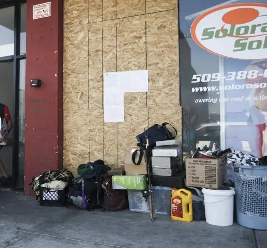 Boarded entrance and site-securing supplies at Savoy Apartments in Yakima